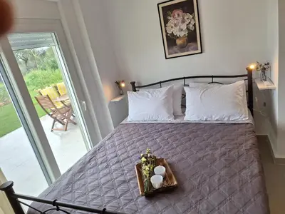 a bedroom with a bed with a tray of food on it at Iris&Phaedra in Ayiá