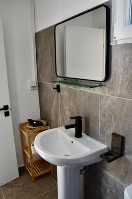 a bathroom with a sink and a mirror on the wall at Agros simple living in Frangokastello