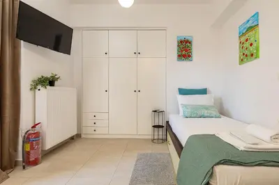 a small bedroom with a bed and a tv at Koum Kapi Mare Studios C2 in Chania Town