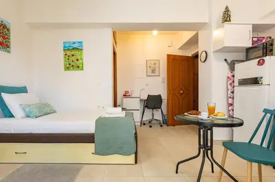 a small room with a bed and a table at Koum Kapi Mare Studios C2 in Chania Town