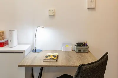 a table with a lamp and a book on it at Koum Kapi Mare Studios C2 in Chania Town