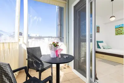a small table in a room with a balcony at Koum Kapi Mare Studios C2 in Chania Town