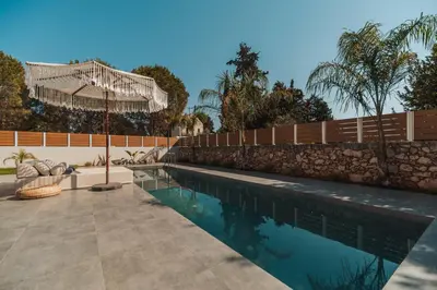 a swimming pool in a yard with a fence at Nos Aqua Villas Chania in Pazinos