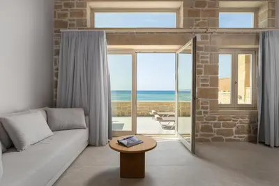 a living room with a couch and a view of the ocean at Villa Maistros in Kissamos