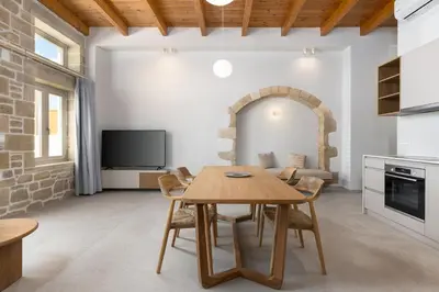a kitchen and dining room with a wooden table and chairs at Villa Maistros in Kissamos