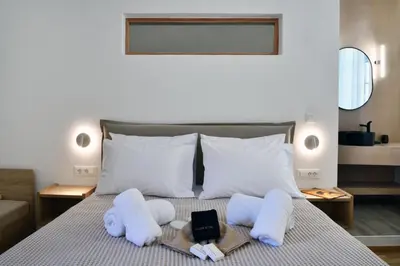 a hotel room with a bed with towels and a tablet at Casa Kallisti in Chania Town