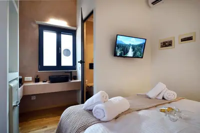 a bedroom with a bed with towels on it at Casa Kallisti in Chania Town