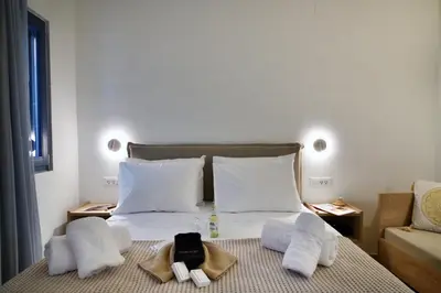 a bedroom with a bed with towels on it at Casa Kâllisti Grande in Chania Town