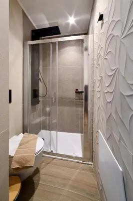 a bathroom with a shower and a white toilet at Casa Kâllisti Grande in Chania Town