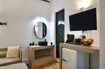 a living room with a tv on a wall at Casa Kâllisti Grande in Chania Town
