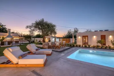 a backyard with a swimming pool and a house at Superior Argilos Cottage Private Pool - 300m From the beach in Korfalónas