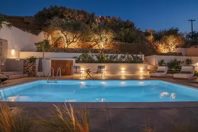 a swimming pool in a backyard at night at Superior Argilos Cottage Private Pool - 300m From the beach in Korfalónas