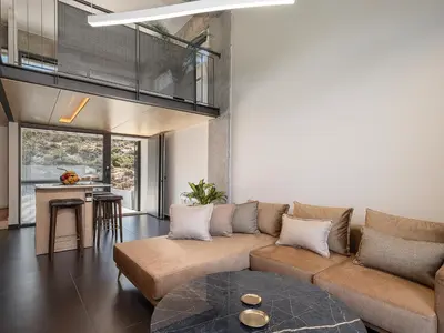 a living room with a couch and a table at Nature's Den in Frangokastello
