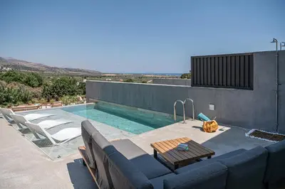 a pool with a couch and a table on a building at Nature's Den in Frangokastello