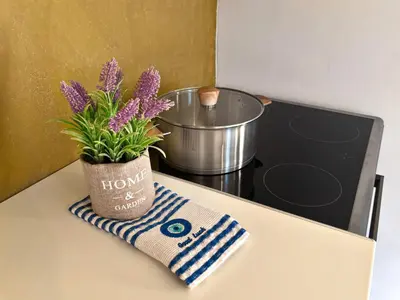 a pot of purple flowers sitting on top of a counter at Mekia's beach house in Livadia
