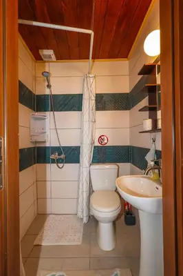 a bathroom with a toilet and a sink at SternesVillage, Premium Balcony Suite in Stérnai