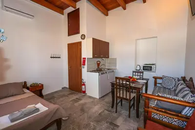 a kitchen and living room with a couch and a table at SternesVillage, Premium Balcony Suite in Stérnai