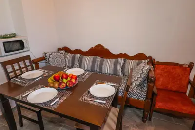 a table with plates and a bowl of fruit on it at SternesVillage, Premium Balcony Suite in Stérnai