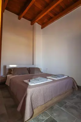 a bedroom with a large bed in a room at SternesVillage, Premium Balcony Suite in Stérnai