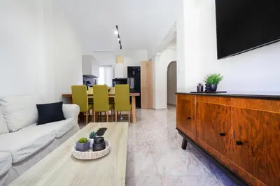 a living room with a couch and a tv at Sophia Apartment in Chania Town