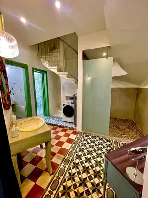 a large room with a kitchen with a table and a floor at La Sistina in Chania Town