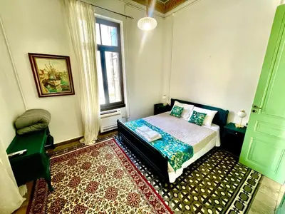 a bedroom with a bed and a window and a rug at La Sistina in Chania Town