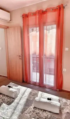 a room with two windows and two towels on the floor at Christina & Suzan Apartment in Chania Town