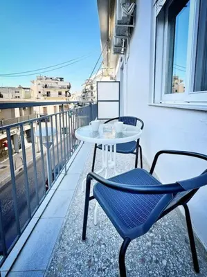 a table and chairs on the balcony of a building at Christina & Suzan Apartment in Chania Town