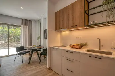 a kitchen with a table and a dining room at Kiwi Boutique Studios in Kissamos
