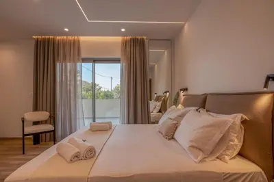 a bedroom with a large bed with white pillows at Kiwi Boutique Studios in Kissamos