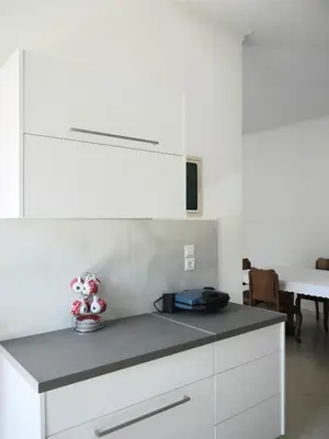 a kitchen with white cabinets and a counter top at Kouklospito in Chania Town