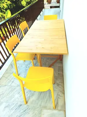 a wooden table and chairs on a balcony at Kouklospito in Chania Town