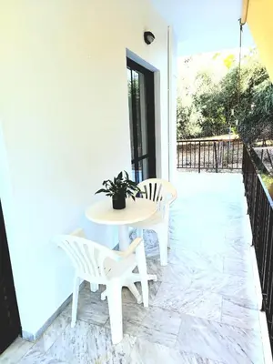 a white table and chairs on a patio at Kouklospito in Chania Town