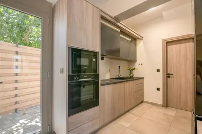 a kitchen with a sink and a stove at Vissalo Studios in Kissamos