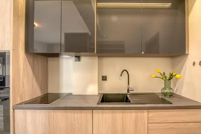 a kitchen with a sink and a vase of flowers at Vissalo Studios in Kissamos