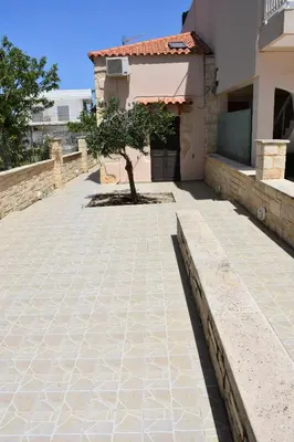 a patio with a tree in the middle of a house at Stefanie's House in Chania Town