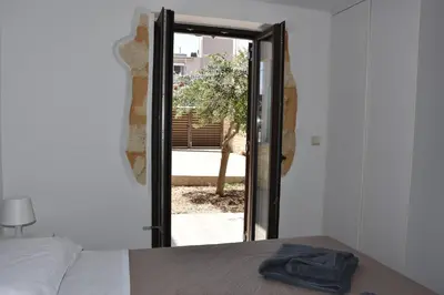 a bedroom with a door open to a patio at Stefanie's House in Chania Town