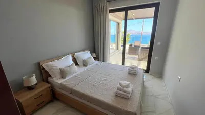 a bedroom with a bed with a view of the ocean at Fiorella Sea View Pool Villa in Kalyves, Chania area, Crete in Kalyves
