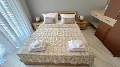 a bedroom with a bed with two towels on it at Fiorella Sea View Pool Villa in Kalyves, Chania area, Crete in Kalyves