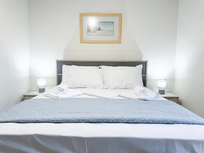 a bed with two pillows on top of it at All Seasons Luxury Apartment in Chania Town