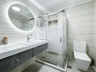 a bathroom with a shower and a toilet and a sink at All Seasons Luxury Apartment in Chania Town