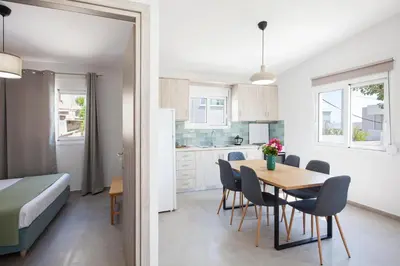a kitchen and dining room with a table and chairs at Peponas Residence in Kato Daratso