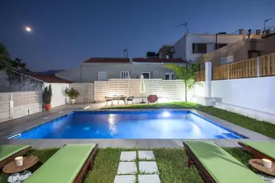 a swimming pool in the backyard of a house at Peponas Residence in Kato Daratso