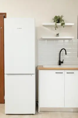 a kitchen with white cabinets and a sink at Ekati Seaside Living in Kolymvari