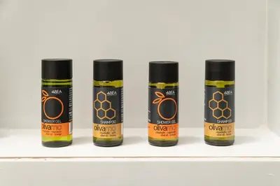 four bottles of honey on a shelf at Ekati Seaside Living in Kolymvari