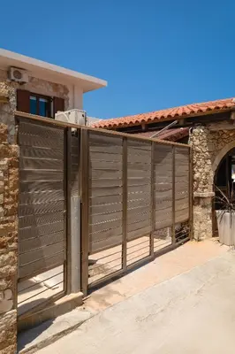a wooden fence in front of a house at Ekati Seaside Living in Kolymvari