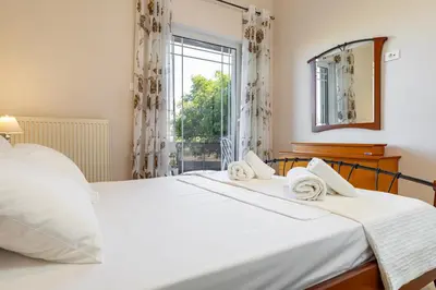 a bedroom with two beds and a window at Blissful Residence with Pool by 8essentially in Daratso