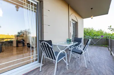 a patio with a table and chairs on a balcony at Blissful Residence with Pool by 8essentially in Daratso