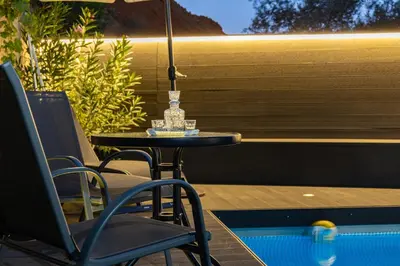 a table and chairs and an umbrella on a patio at Blissful Residence with Pool by 8essentially in Daratso