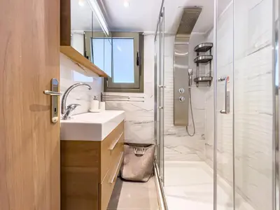 a bathroom with a sink and a shower at Panorama View Apt with Jacuzzi by 8essentially in Daratso